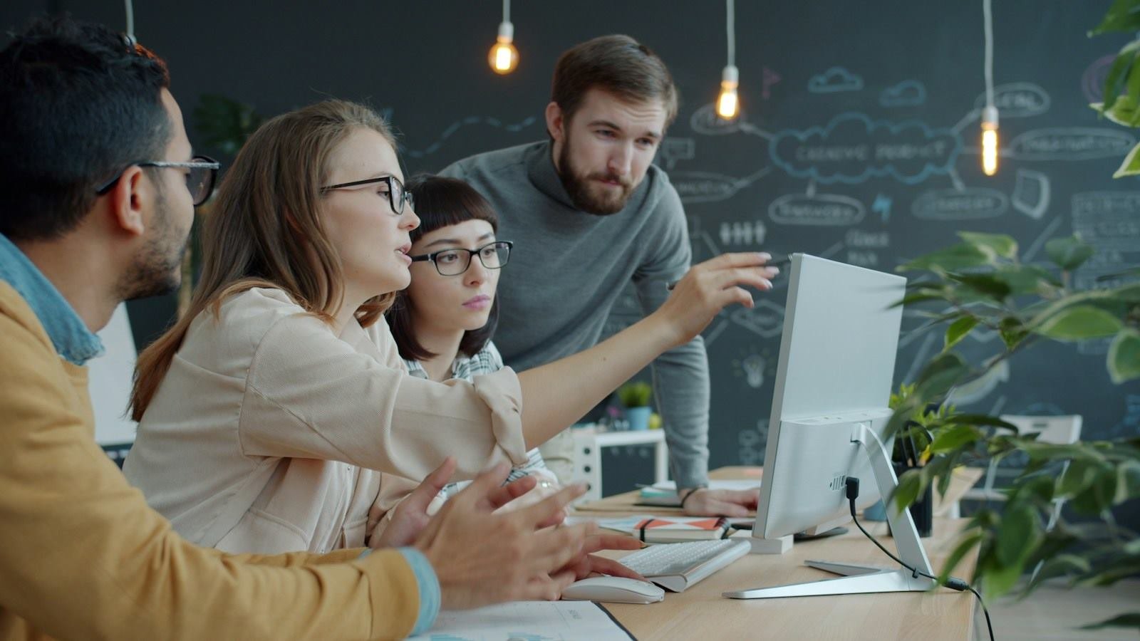 Engineers reviewing work together at a desktop screen